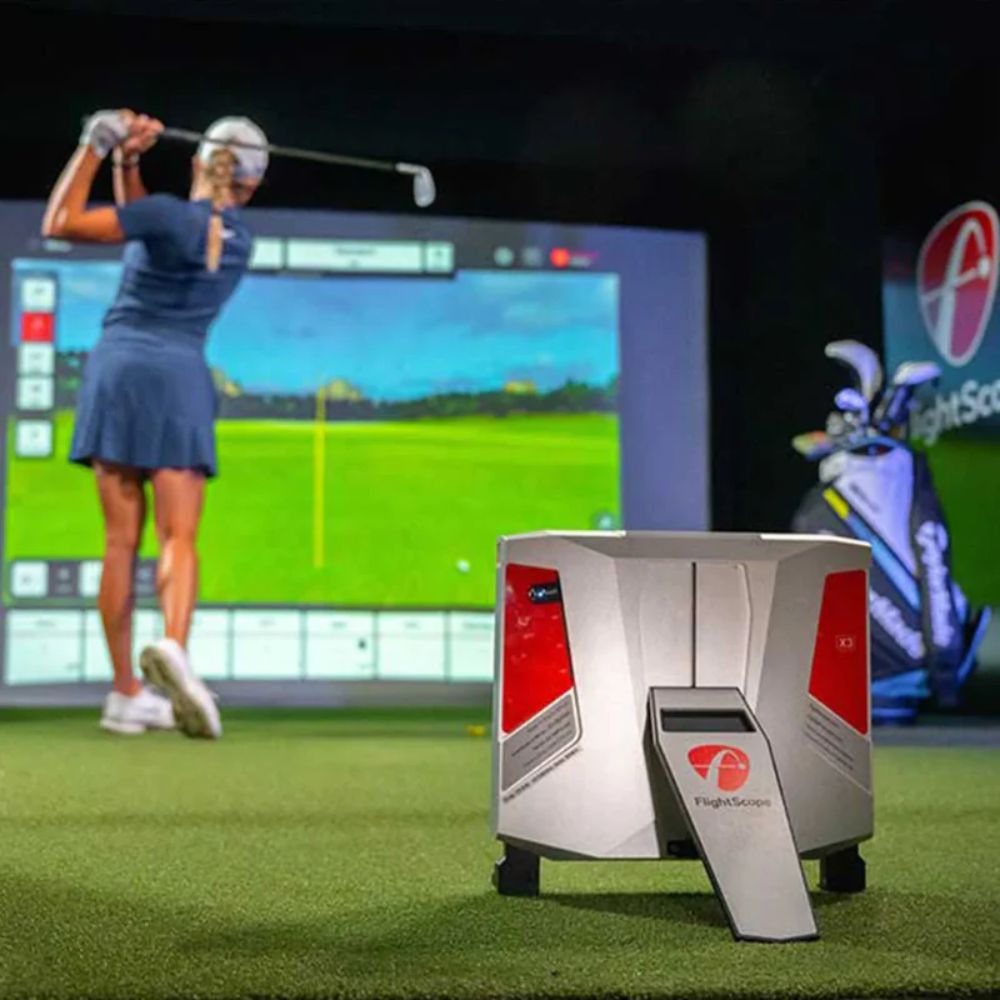 flightscope_X3_launch_monitor_and_golf_simulator_with_lady_swinging_in_front_of_golf_bay