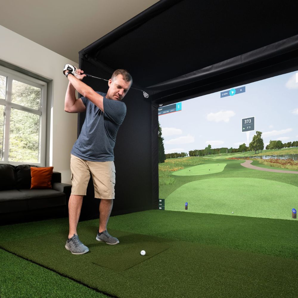 Guy_taking_a_big_swing_in_front_of_a_bayside_golf_enclosure