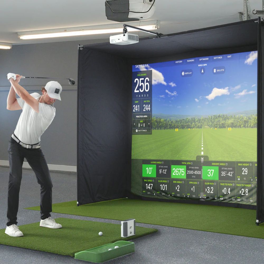 skytrak_golf_simulator_with_guy_swinging_in_front_of_golf_bay