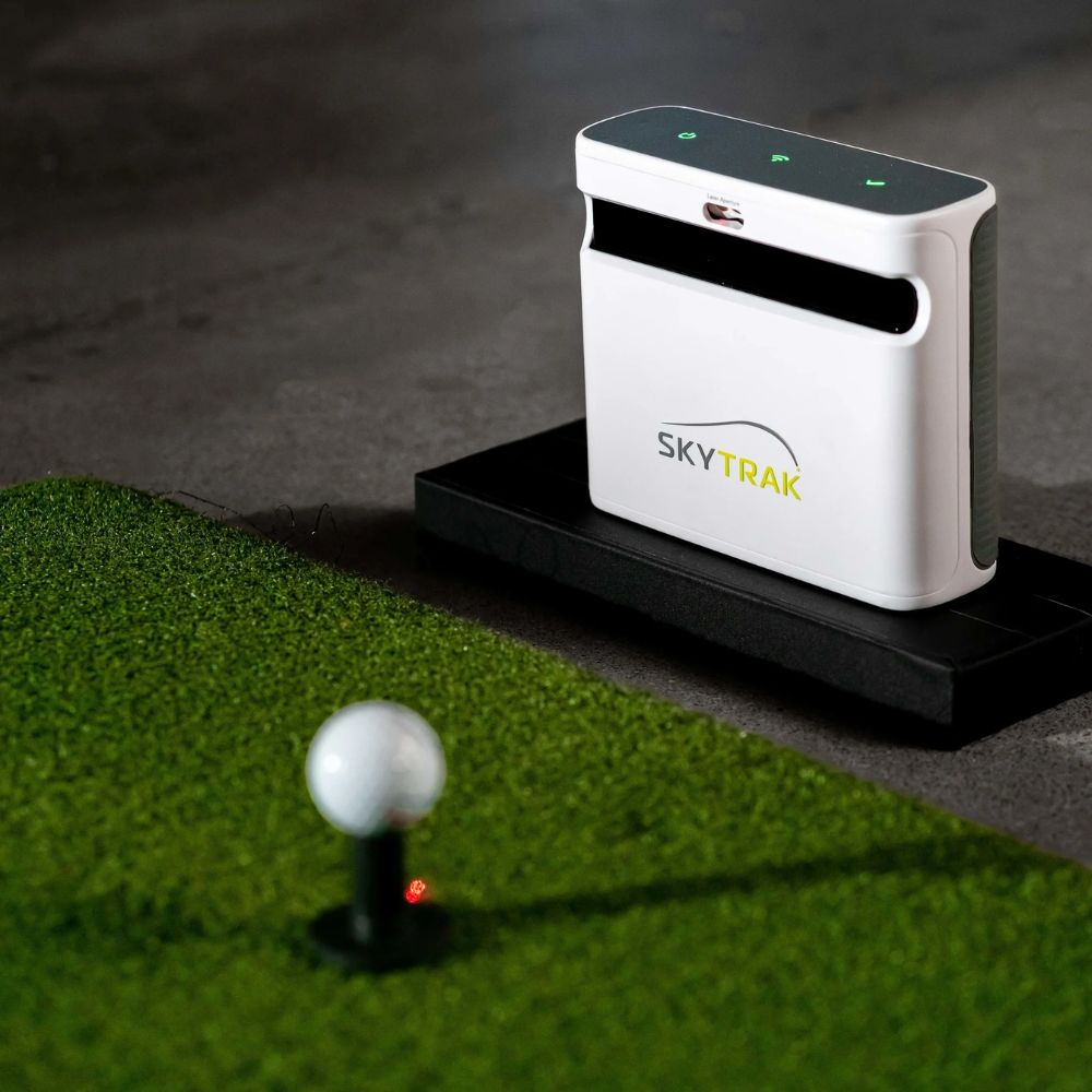 skytrak_launch_monitor_sitting_next_to_a_golf_mat