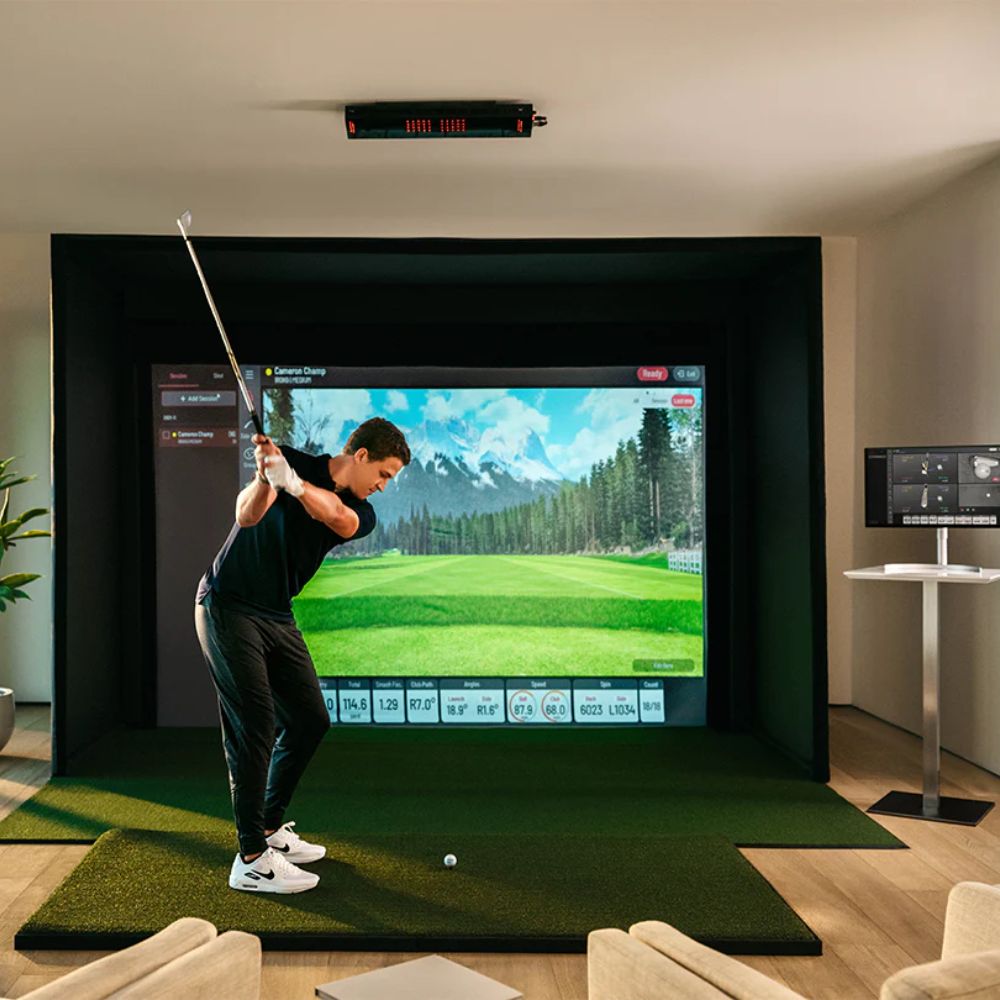 Uneekor golf simulator with guy swinging a club