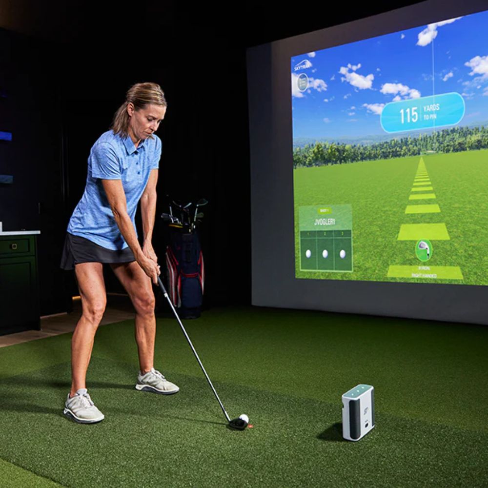 Woman_taking_a_swing_in_front_of_a_bayside_golf_enclosure_with_a_skytrak_launch_monitor